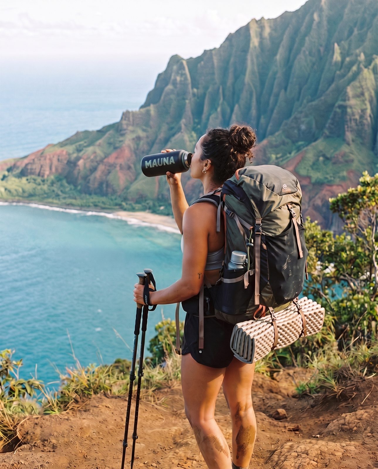 Backpacker drinking from a MAUNA bottle on the Kalalau Trail